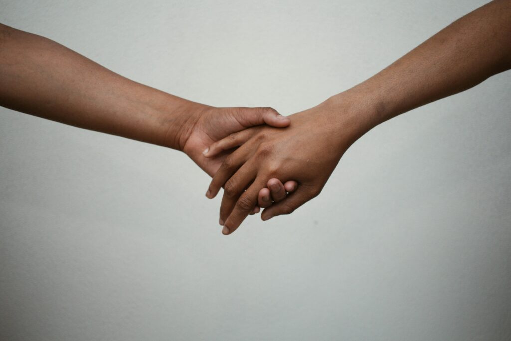 two hands holding each other